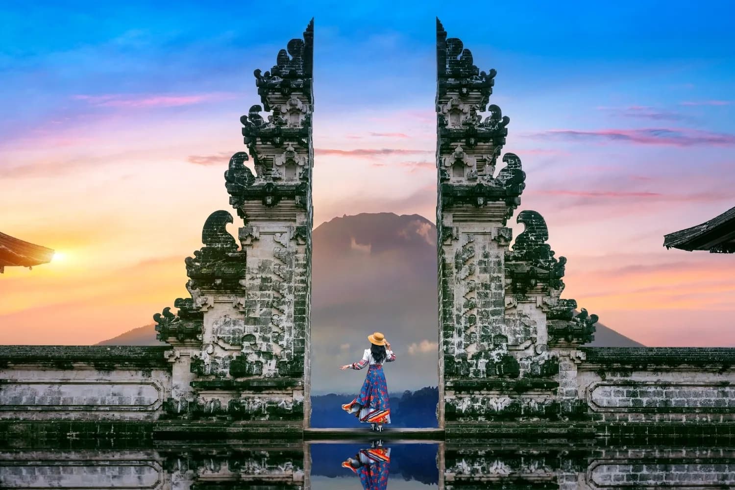 Young woman standing in temple gates at Lempuyang Luhur temple